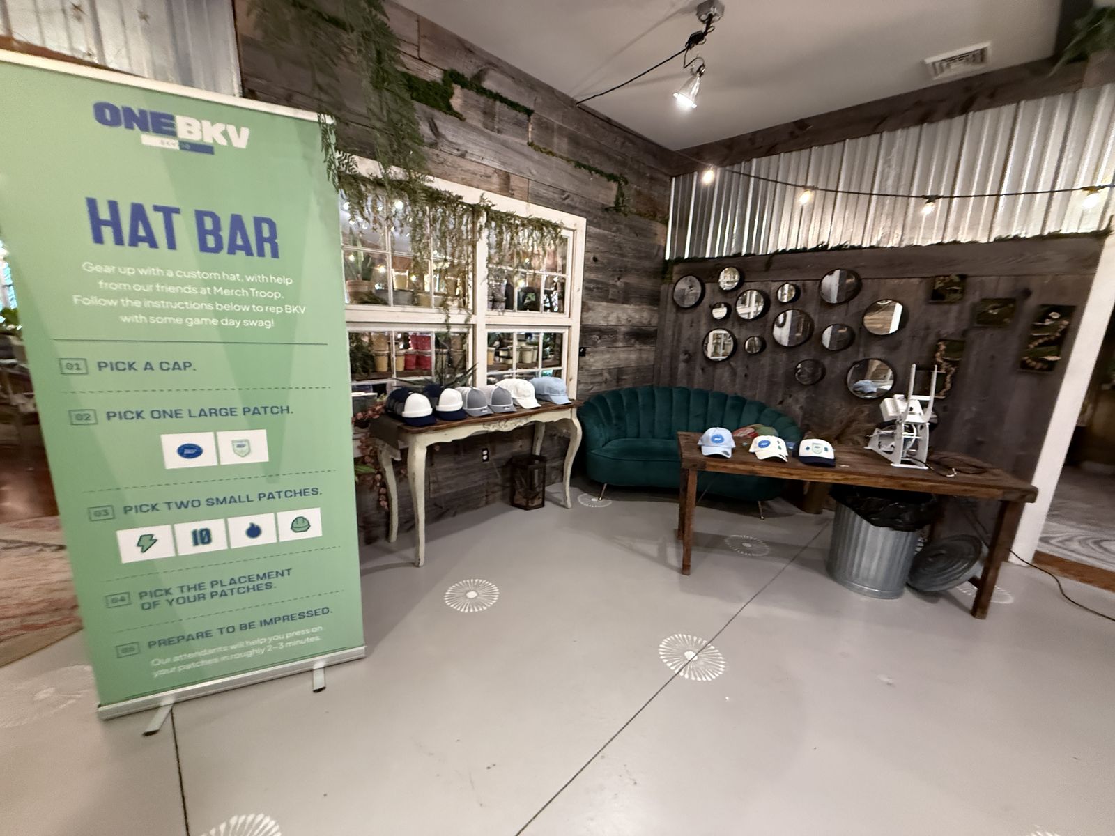 Hat and patch add-on station set up in a lounge beside the embroidery bar