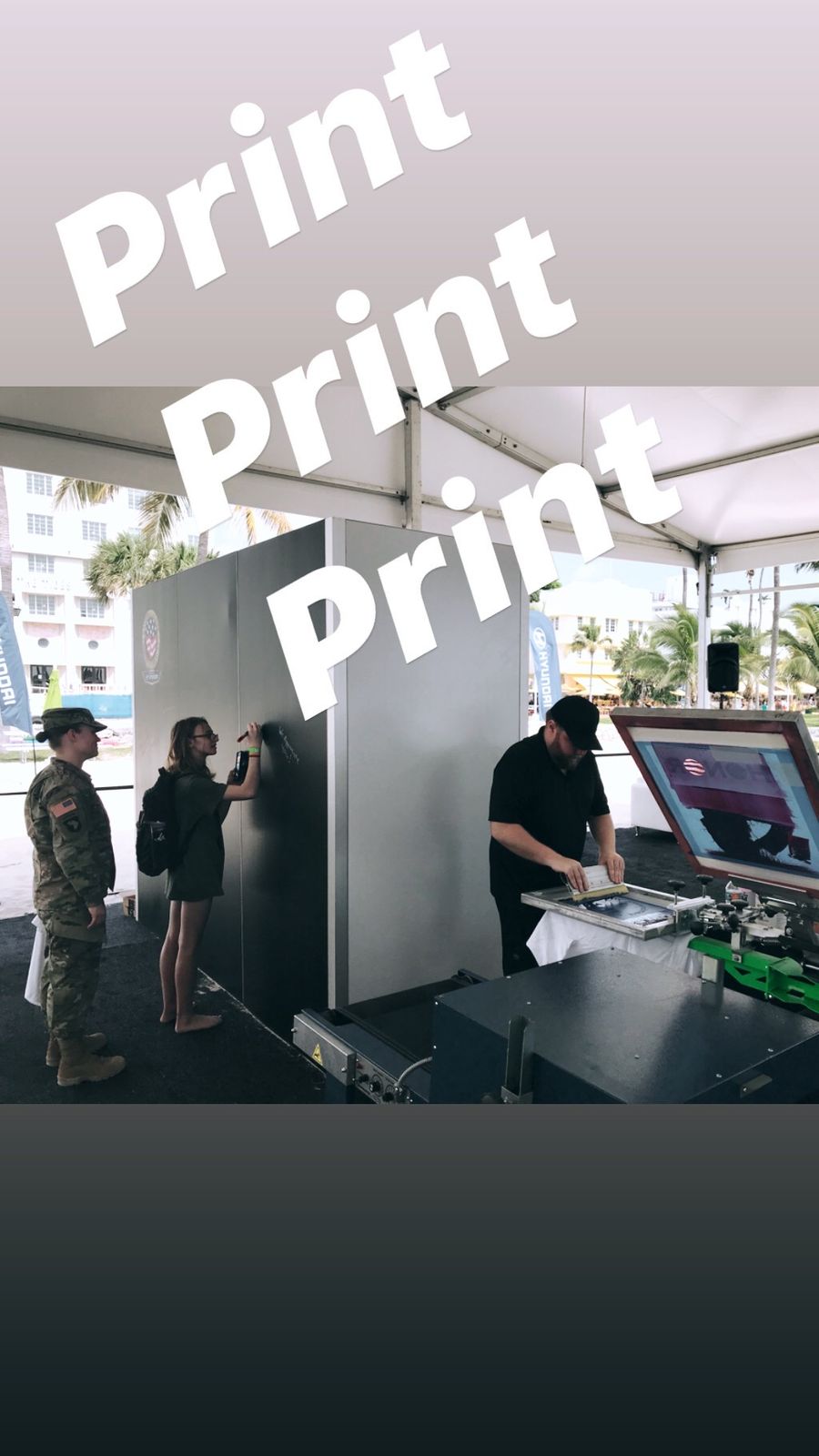Live customization station operating under a canopy tent at an outdoor event